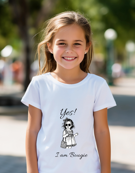 Young white toddler girl with brown hair with earrings wearing a white t-shirt that has an image of a little girl in a dress with sunglasses and purse with the saying Yes! I am Bougie.